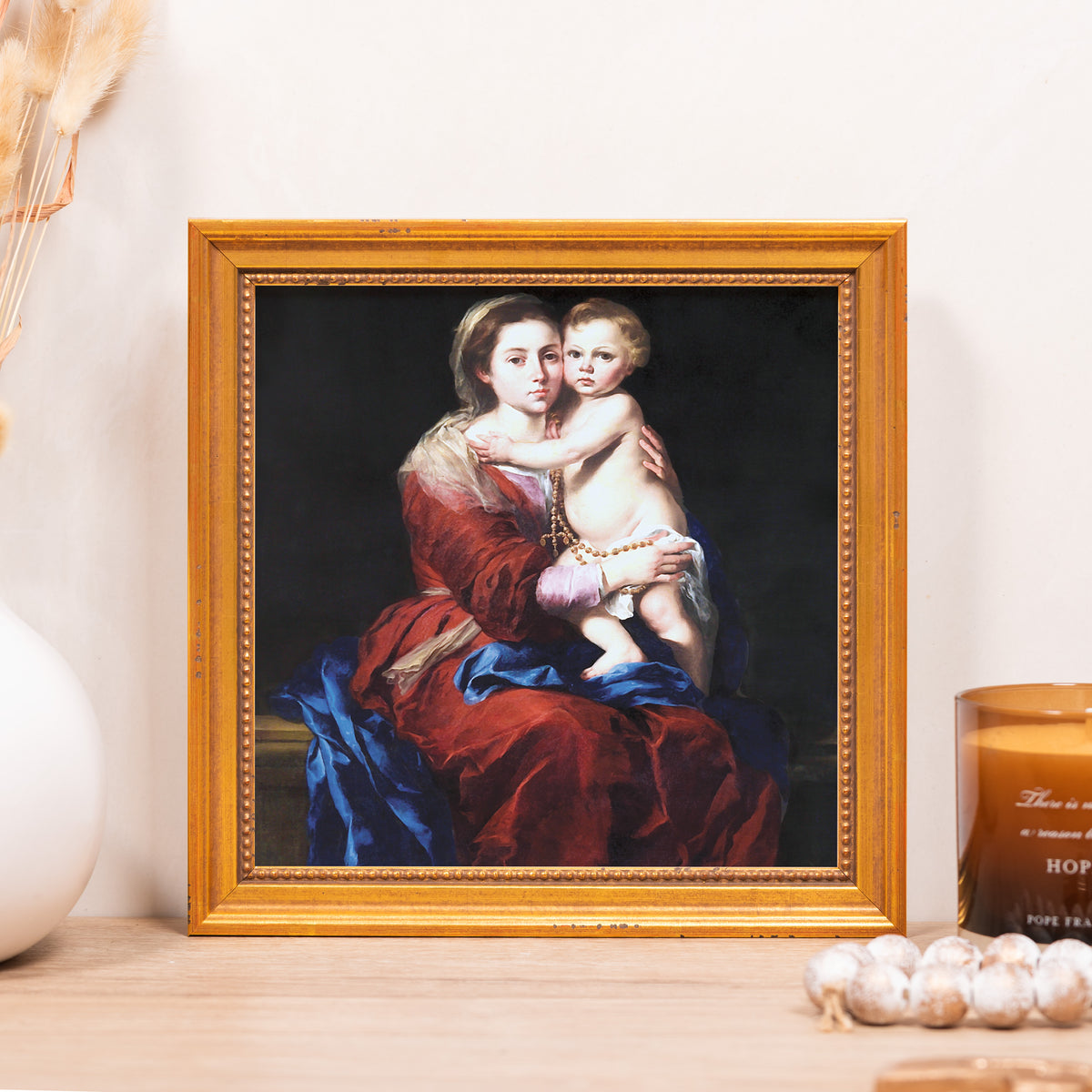 Framed print. Oil painting of the Madonna and child in red and blue, with a gold frame.