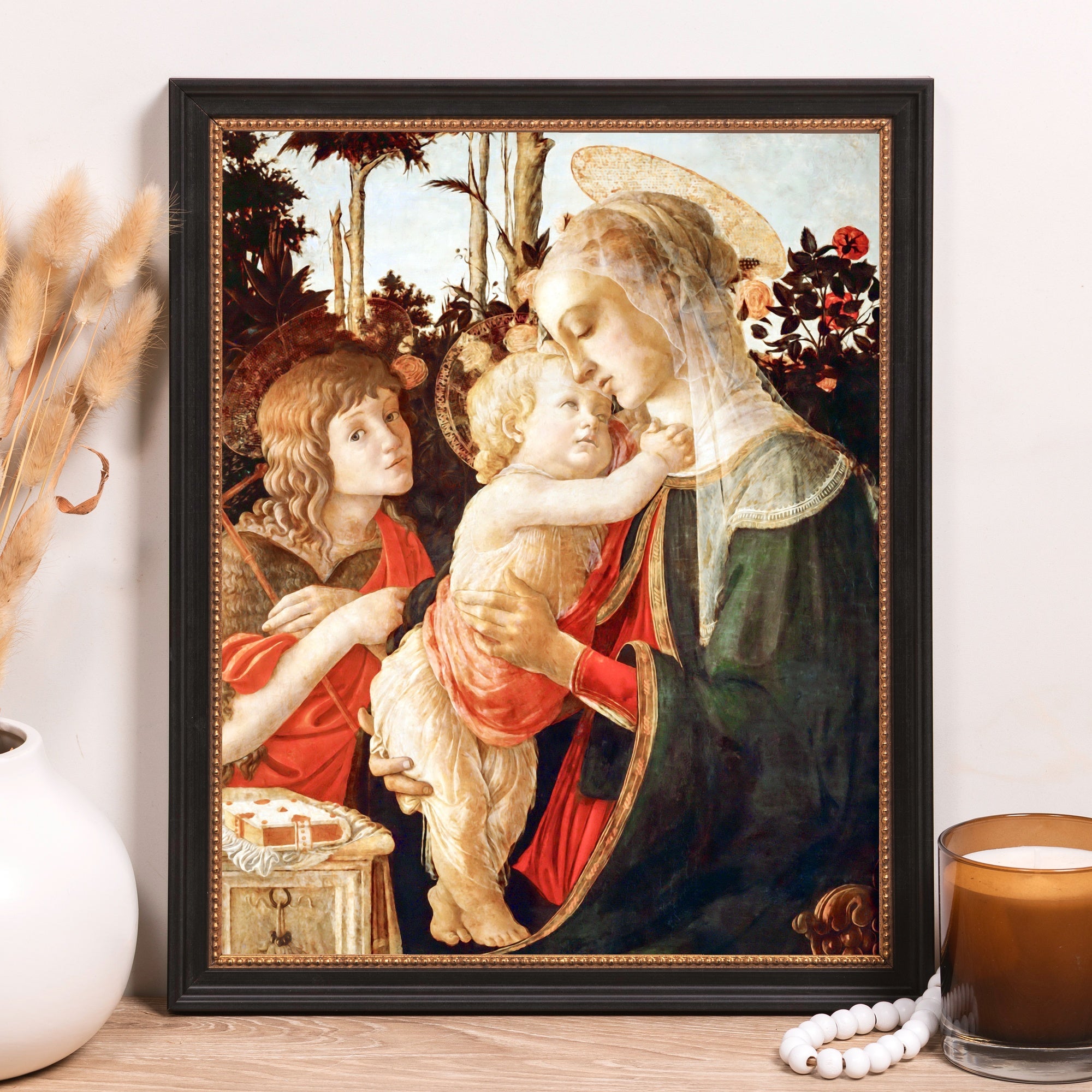 Framed print depicts Madonna and child, renaissance style, black frame.