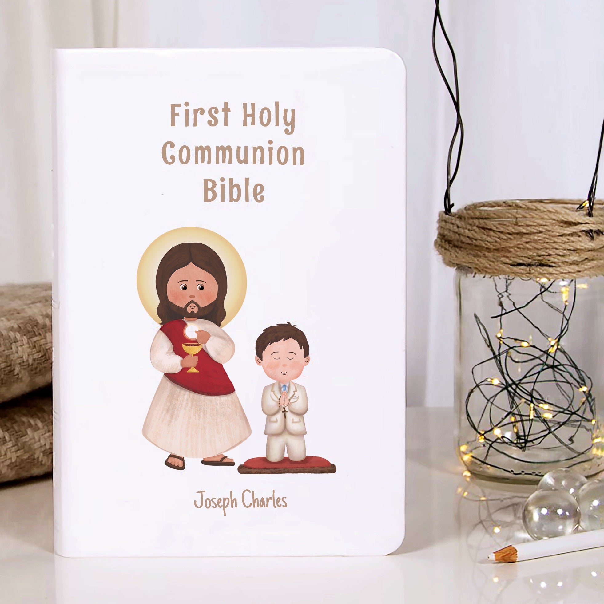 White Hardcover First Holy Communion Bible with religious illustrations.
