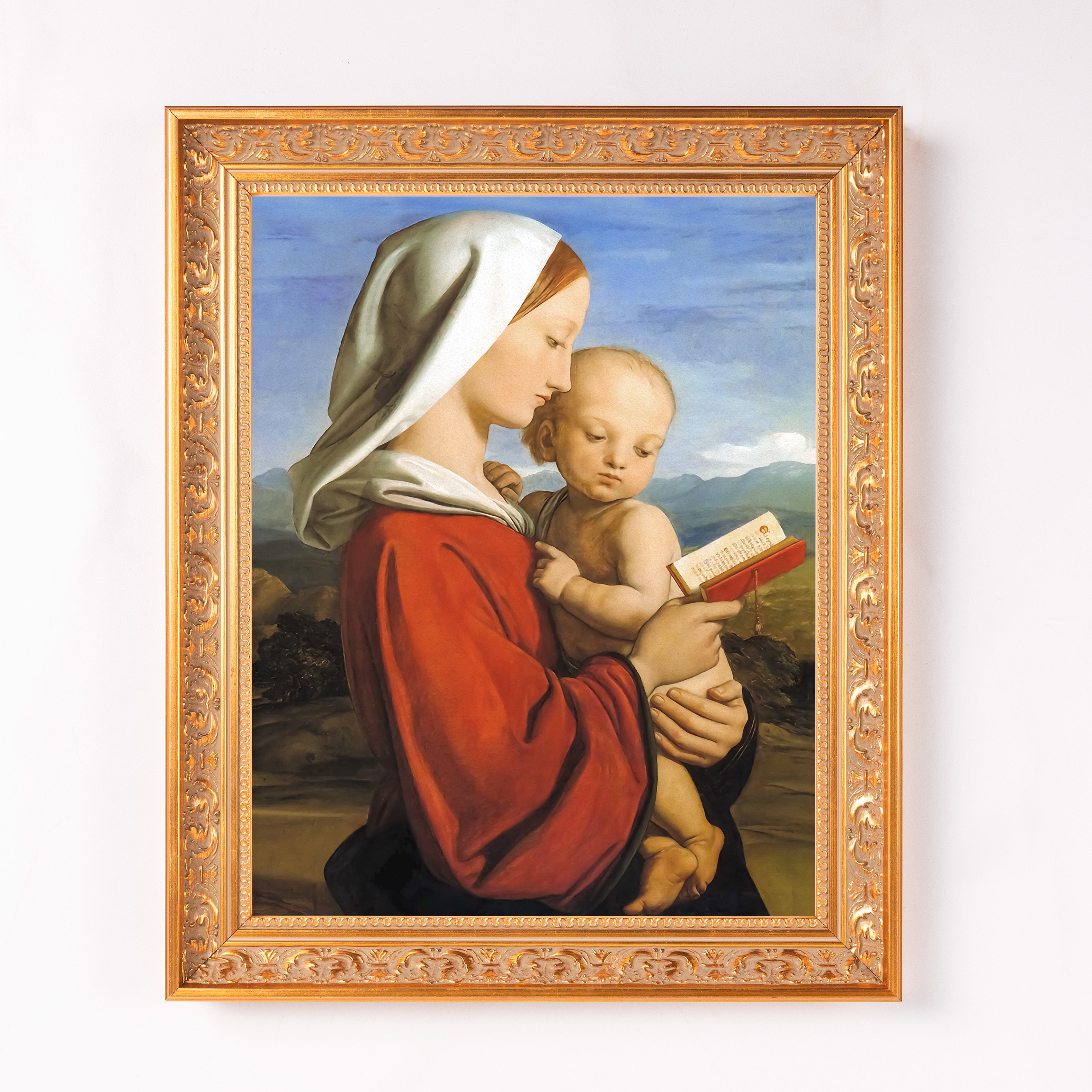 Framed print of the Madonna and child in ornate gold frame and traditional style.