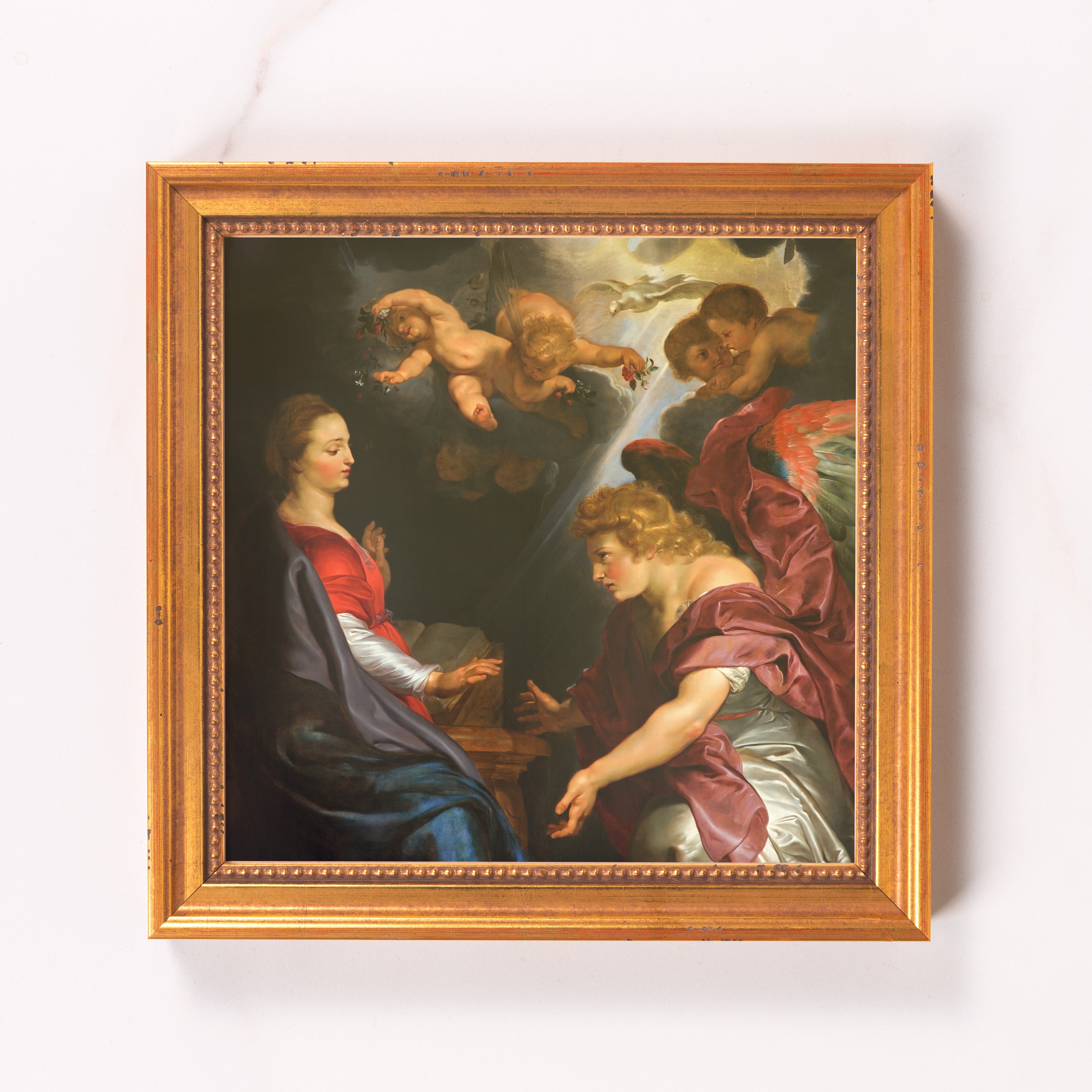 Framed painting of the Annunciation with cherubs, in a gold colored ornate wood frame, Renaissance style.
