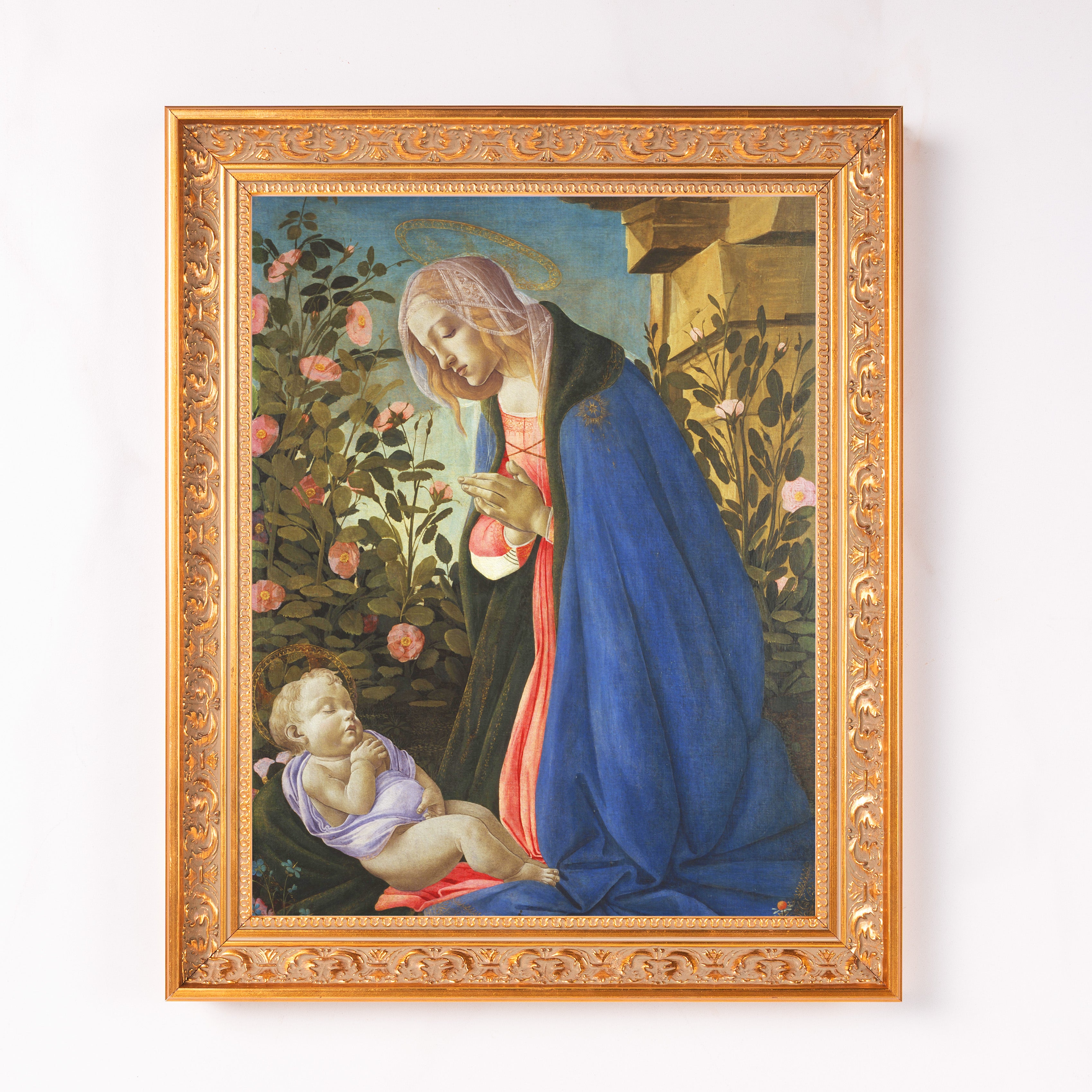 Framed Botticelli style painting of Mary and baby Jesus with blue robe and roses on canvas with gold ornate frame.