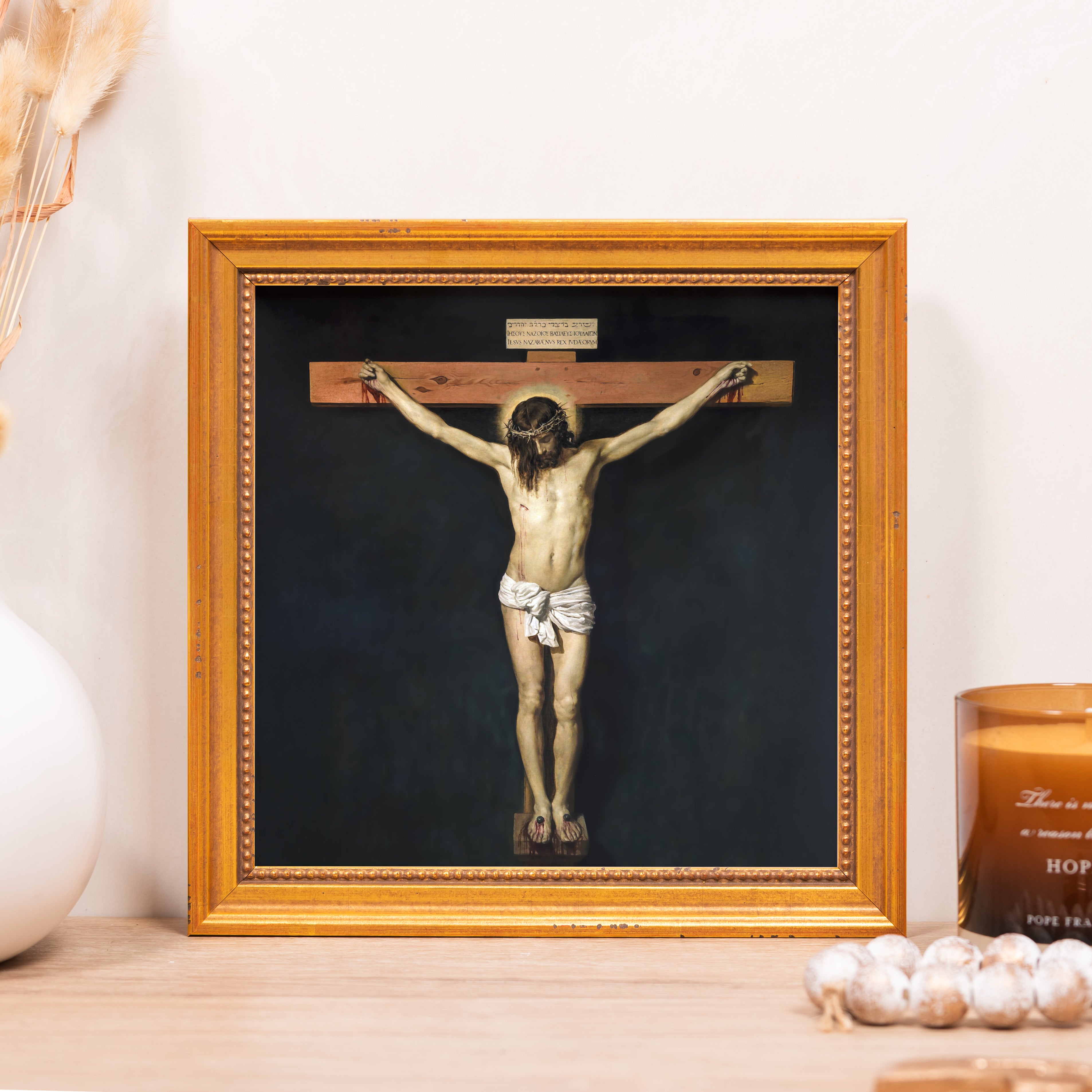 Framed Crucifix depicts Jesus on cross, dark background, gold frame, religious artwork.