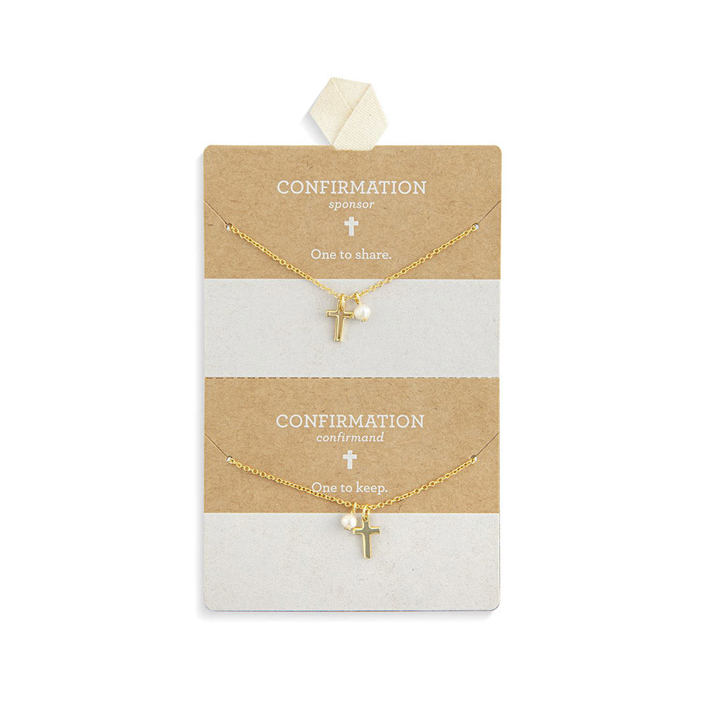 Two gold cross necklaces, one with pearl, on card for Confirmation gifts.
