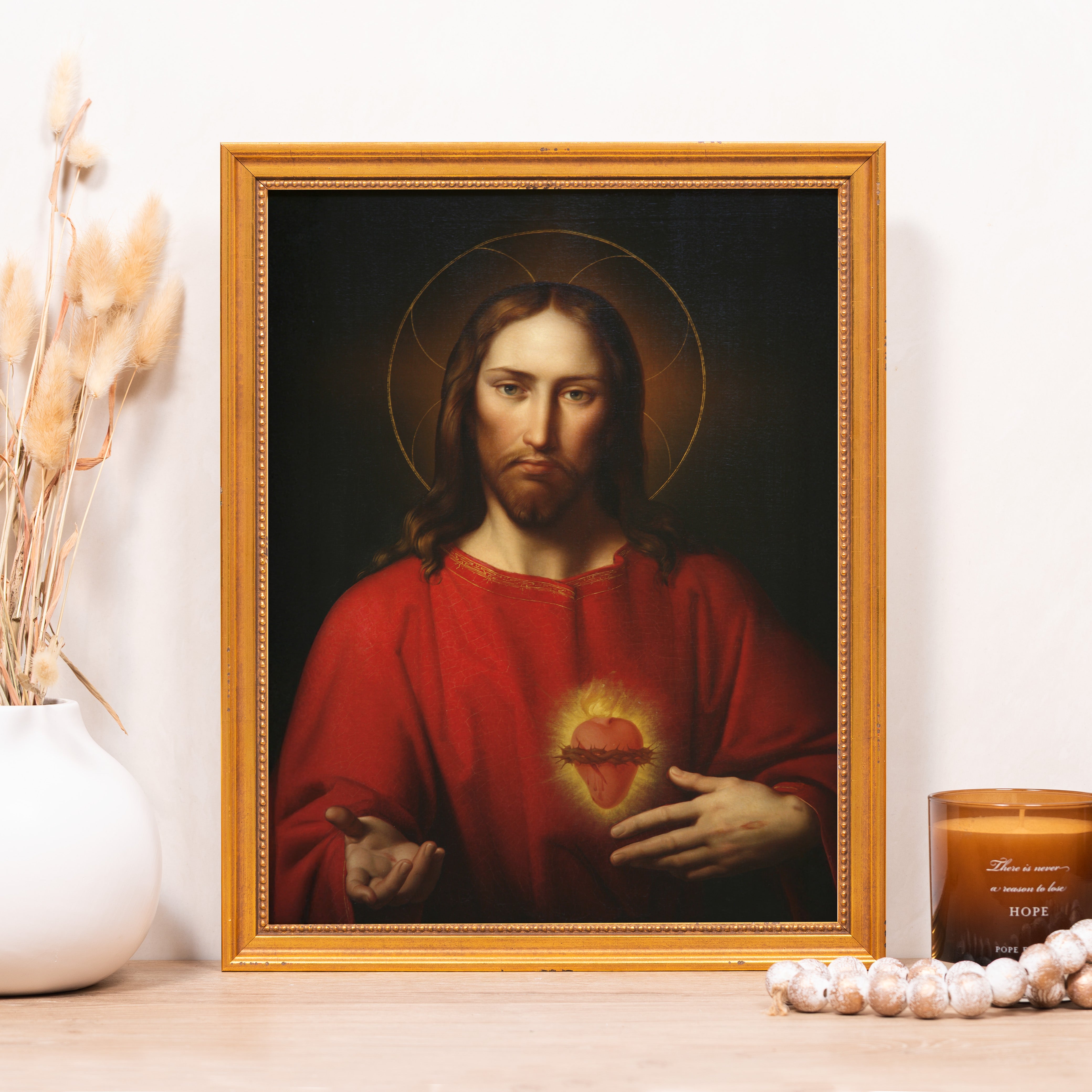 Framed oil painting of Jesus with a golden halo and Sacred Heart, gold frame.