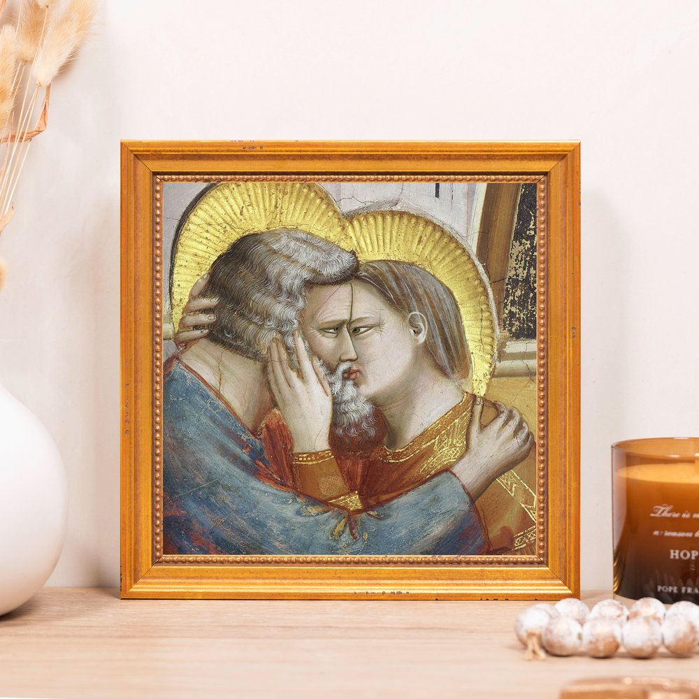 Framed painting of the Kiss of Peace, a religious image in antique style with gold halos.