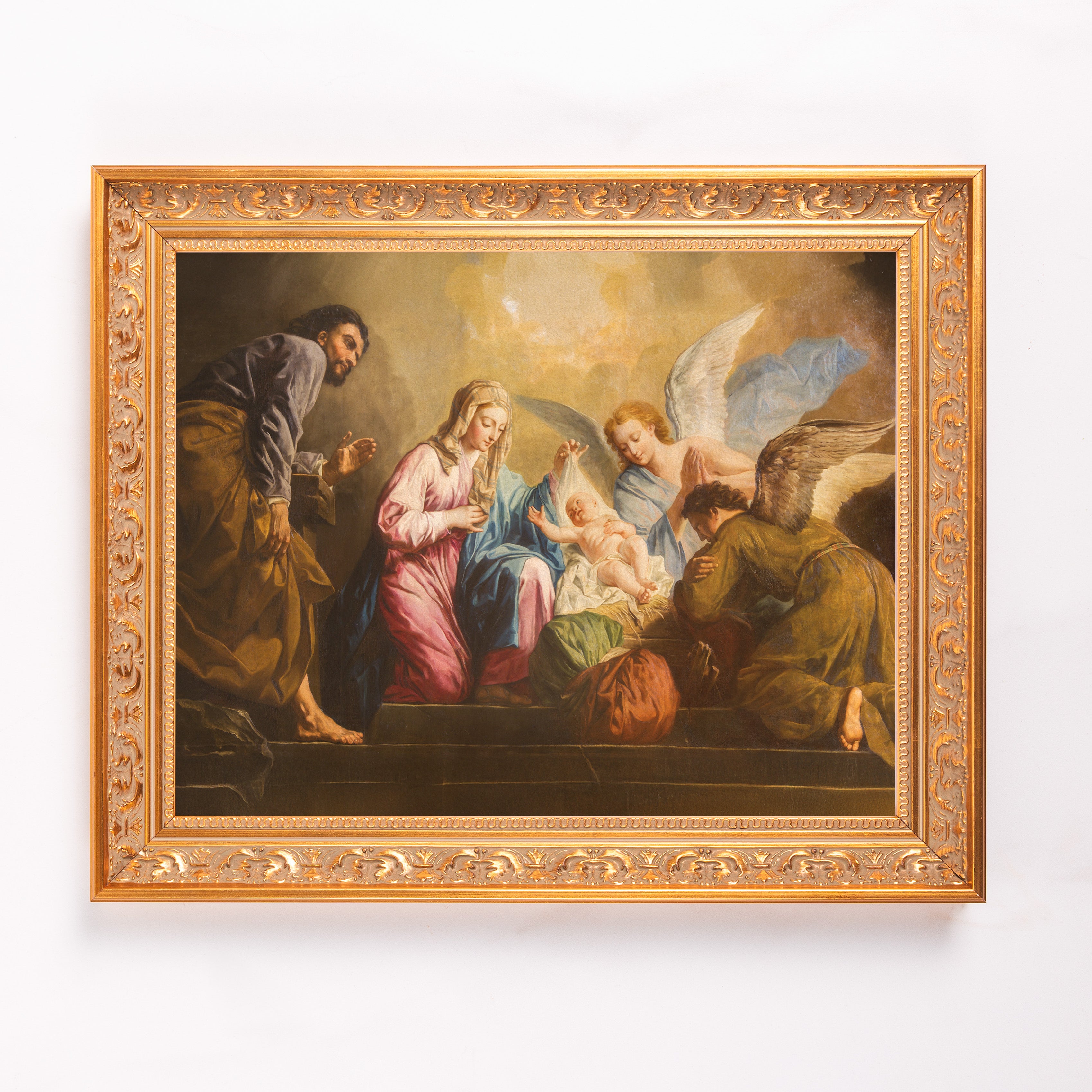 Framed painting depicts the Nativity scene, featuring Mary, Joseph, Angels and baby Jesus in golden colors.