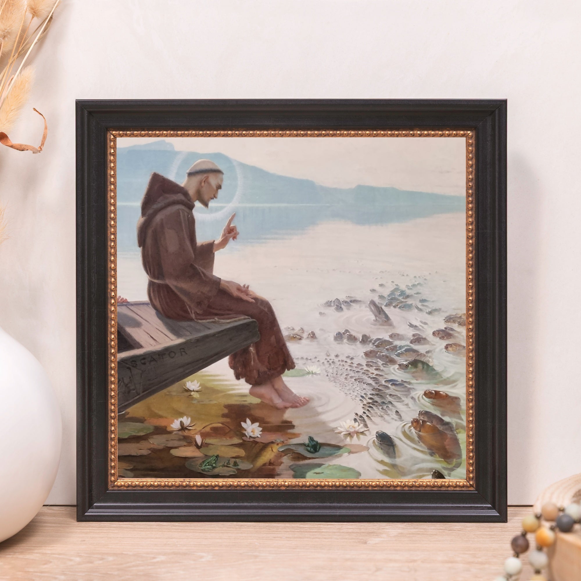 Framed print of Saint Anthony Preaching to the Fish in a black and gold frame.