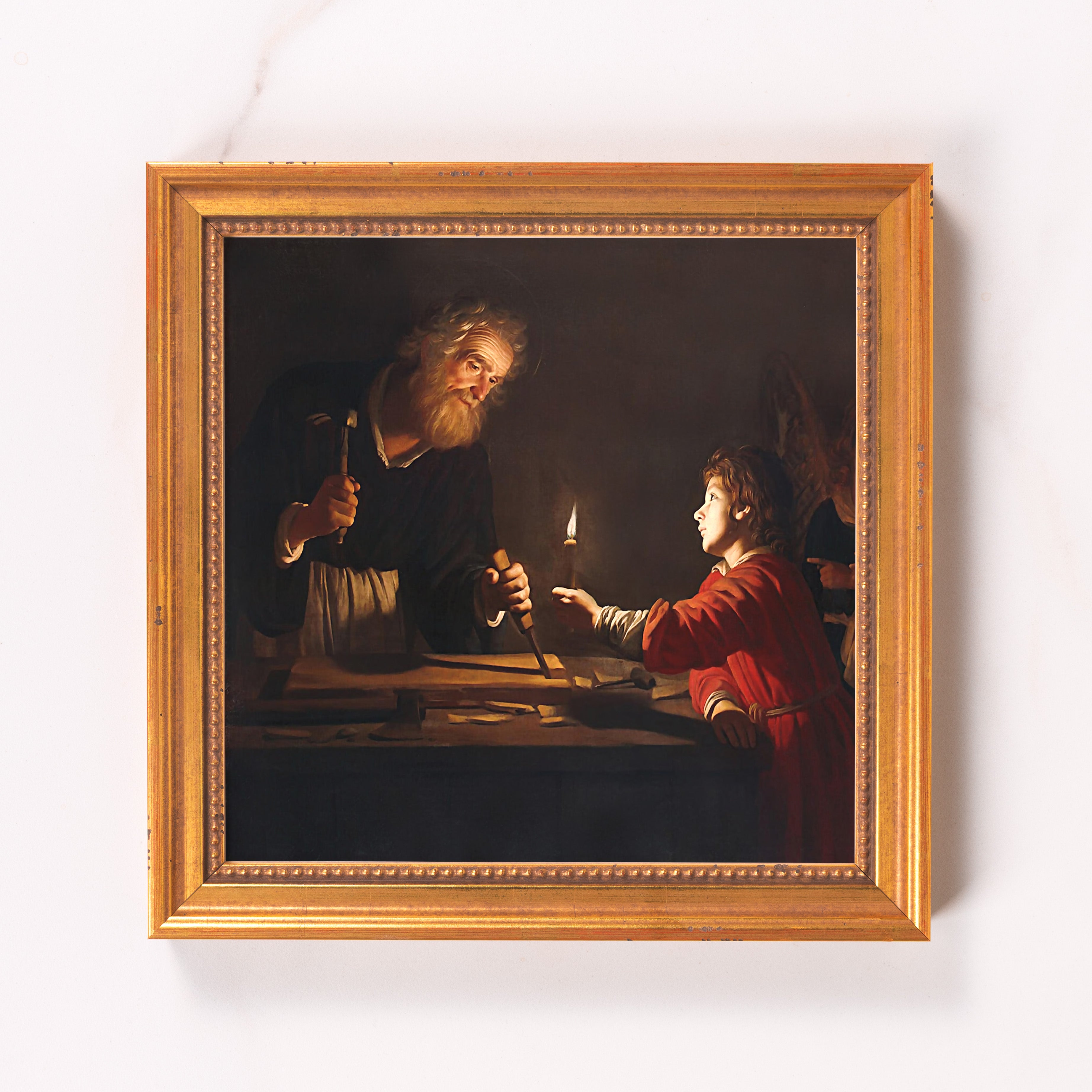 Framed painting depicts Saint Joseph at work with Jesus, oil on canvas in a golden frame.