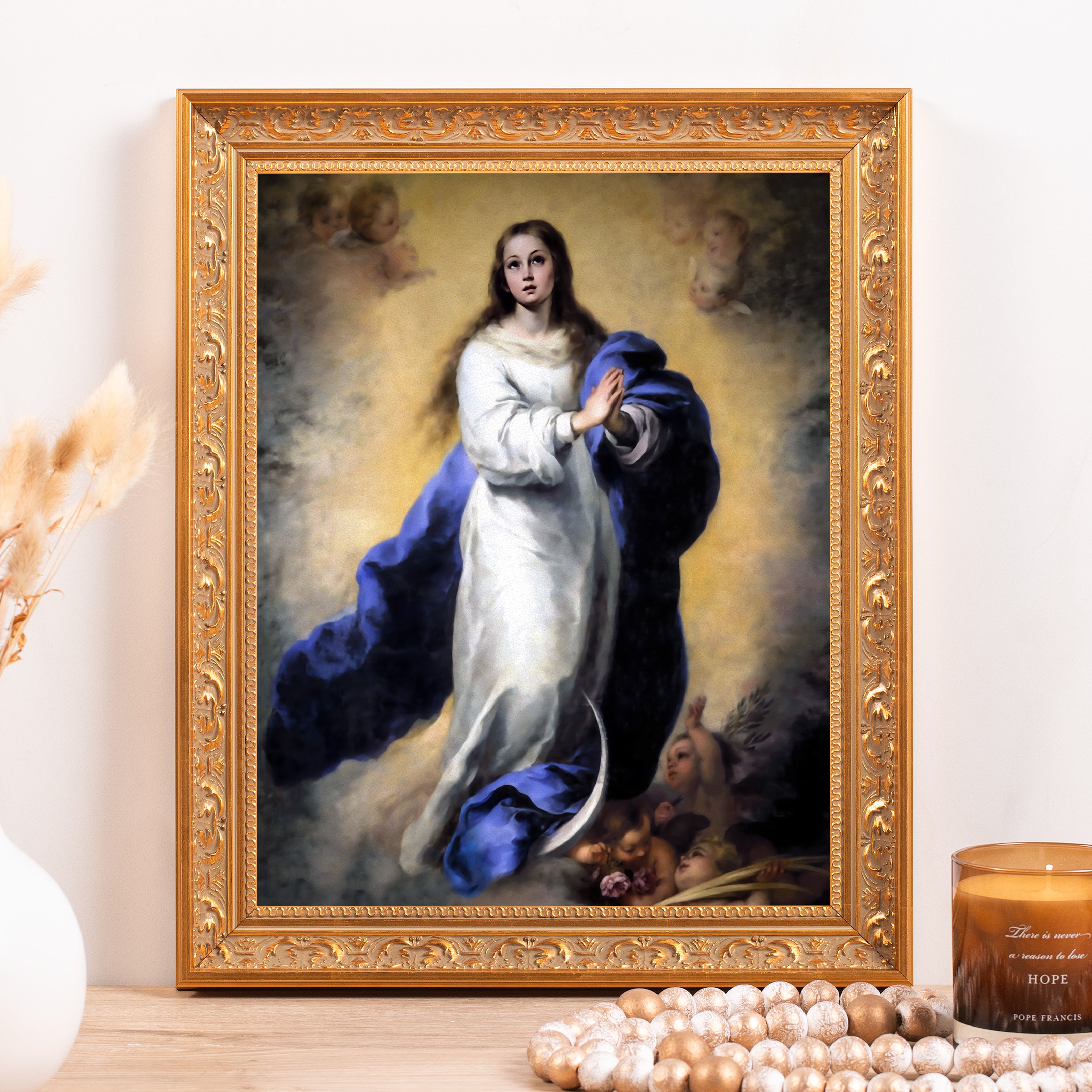 Framed, religious artwork: Virgin Mary with blue cloak, white gown, ornate gold frame, and angels.