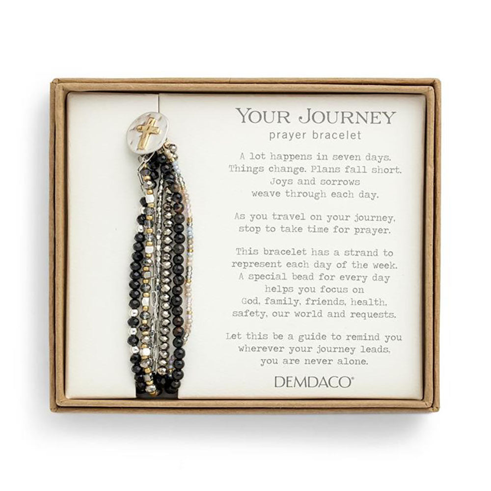 Boxed Prayer bracelet. Beaded strands with a cross charm in silver, black, gold, and beige colors.