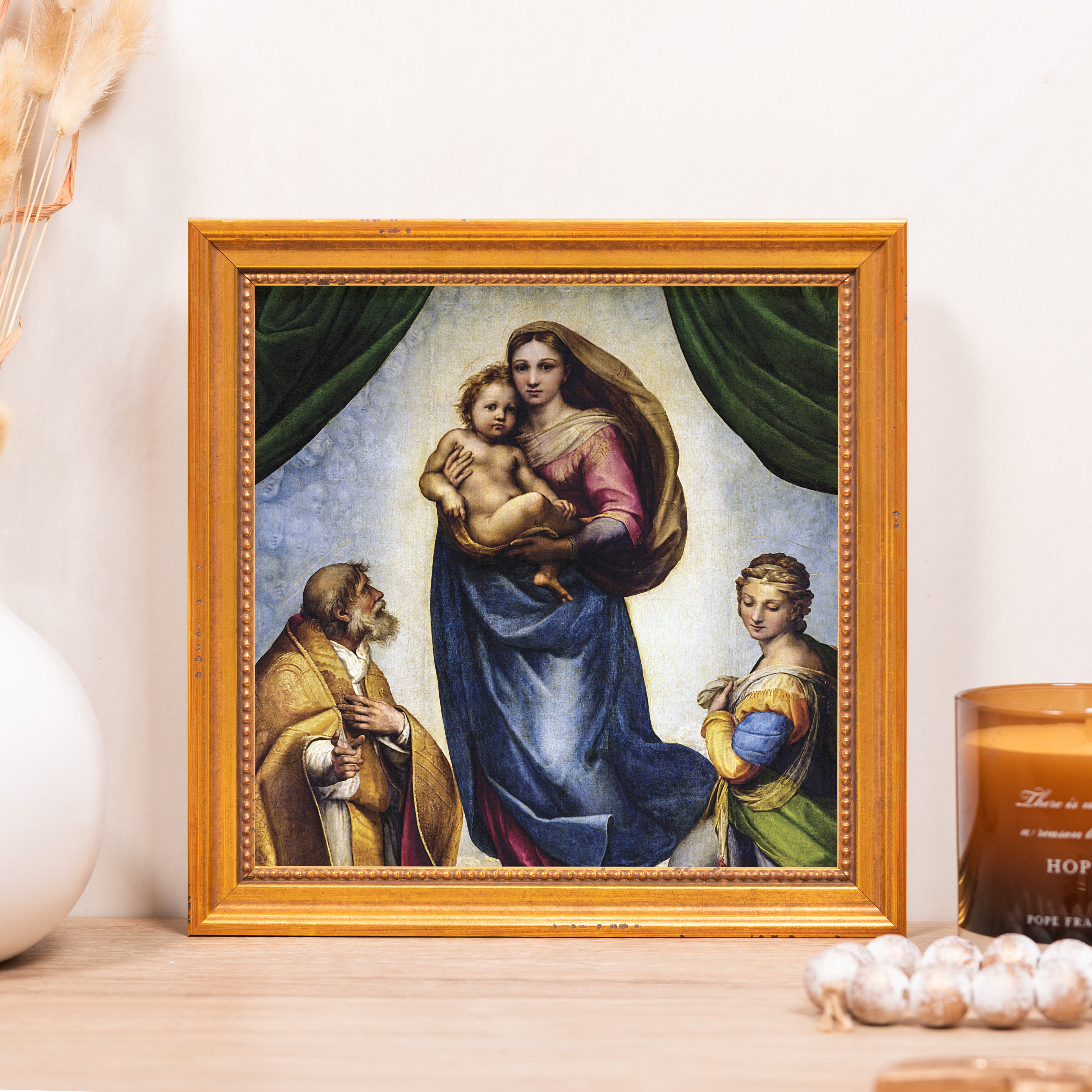 Framed renaissance print of Virgin Mary holding baby Jesus in a gold frame.