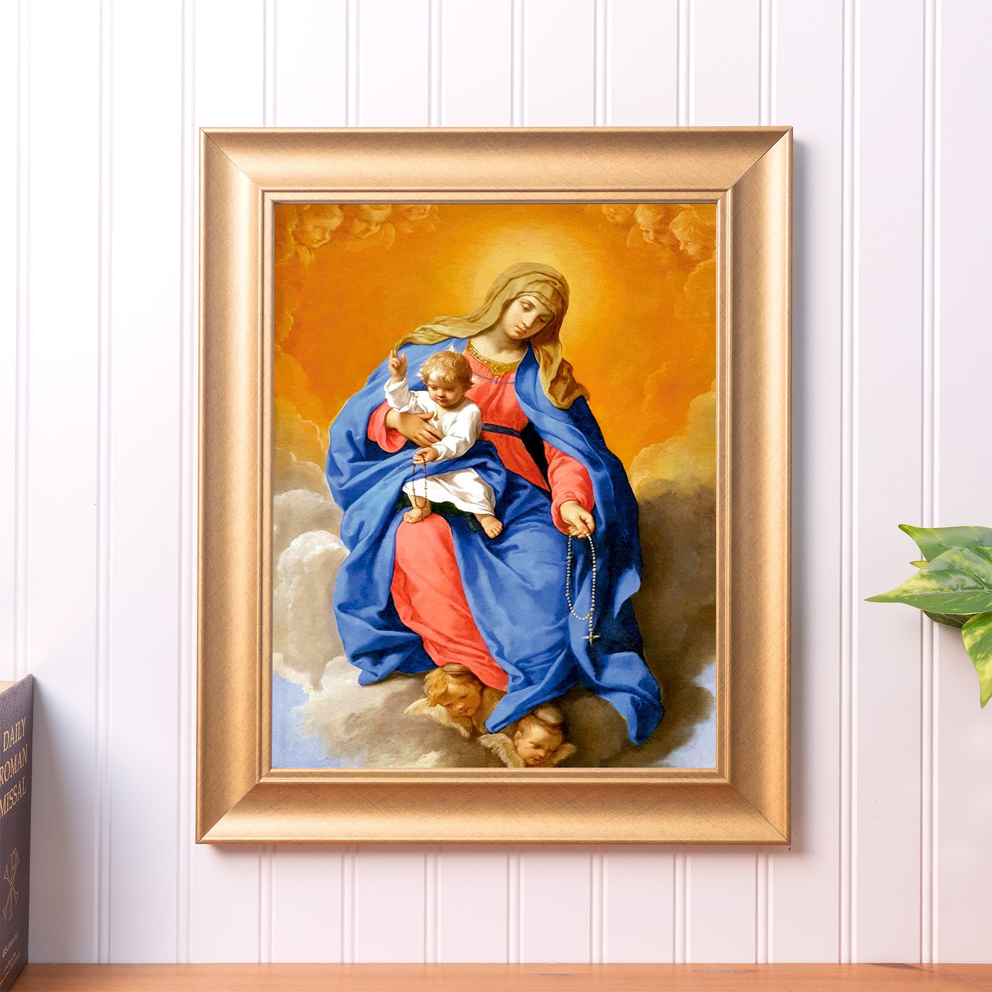 Framed oil painting of Mary and baby Jesus; gold frame, blue and orange tones, religious art piece.
