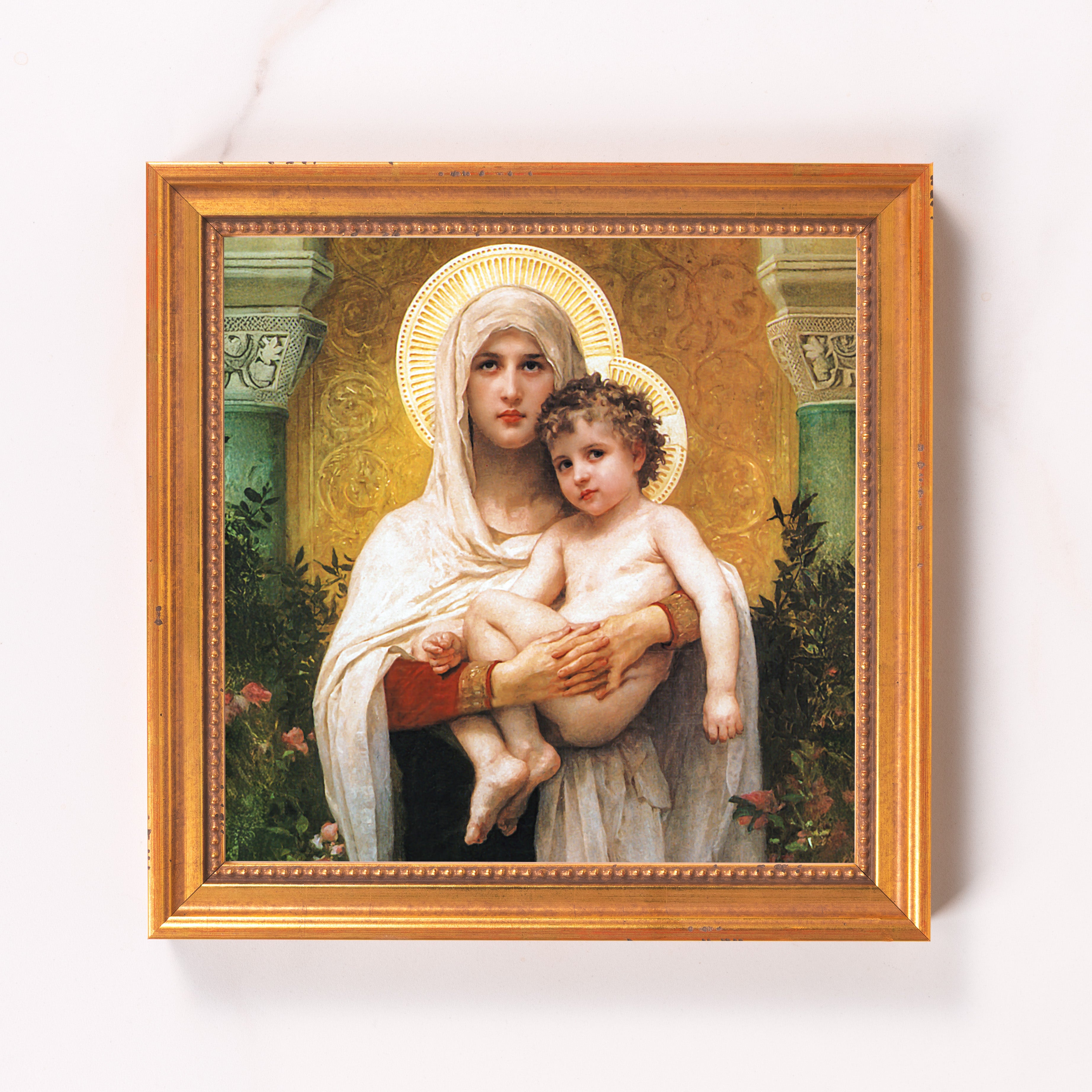 Framed religious art print of mother and child in a gold wood frame.