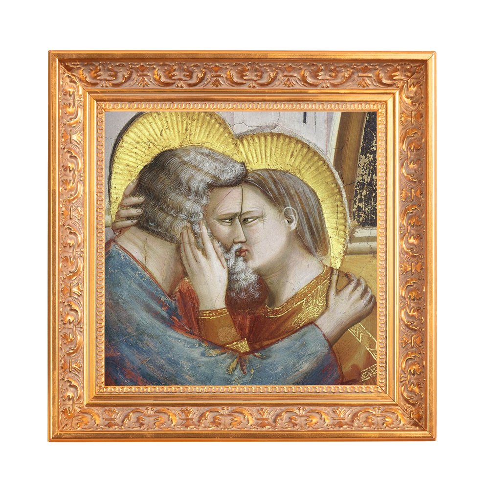 Framed art print depicting a religious embrace, gold halo, and ornate gold frame.