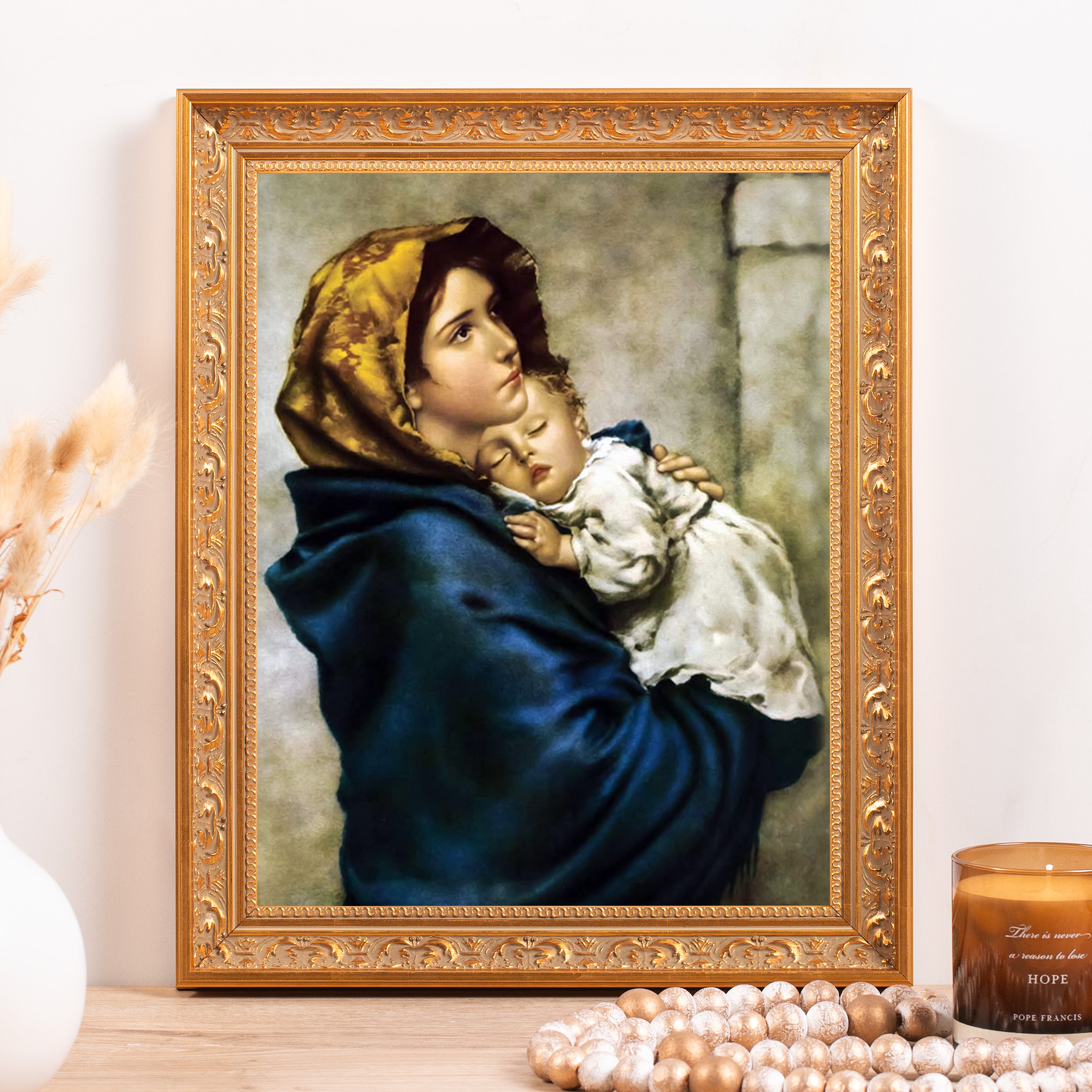 Framed Painting of Madonna and Child with ornate gold frame, blue robe, and yellow head covering.