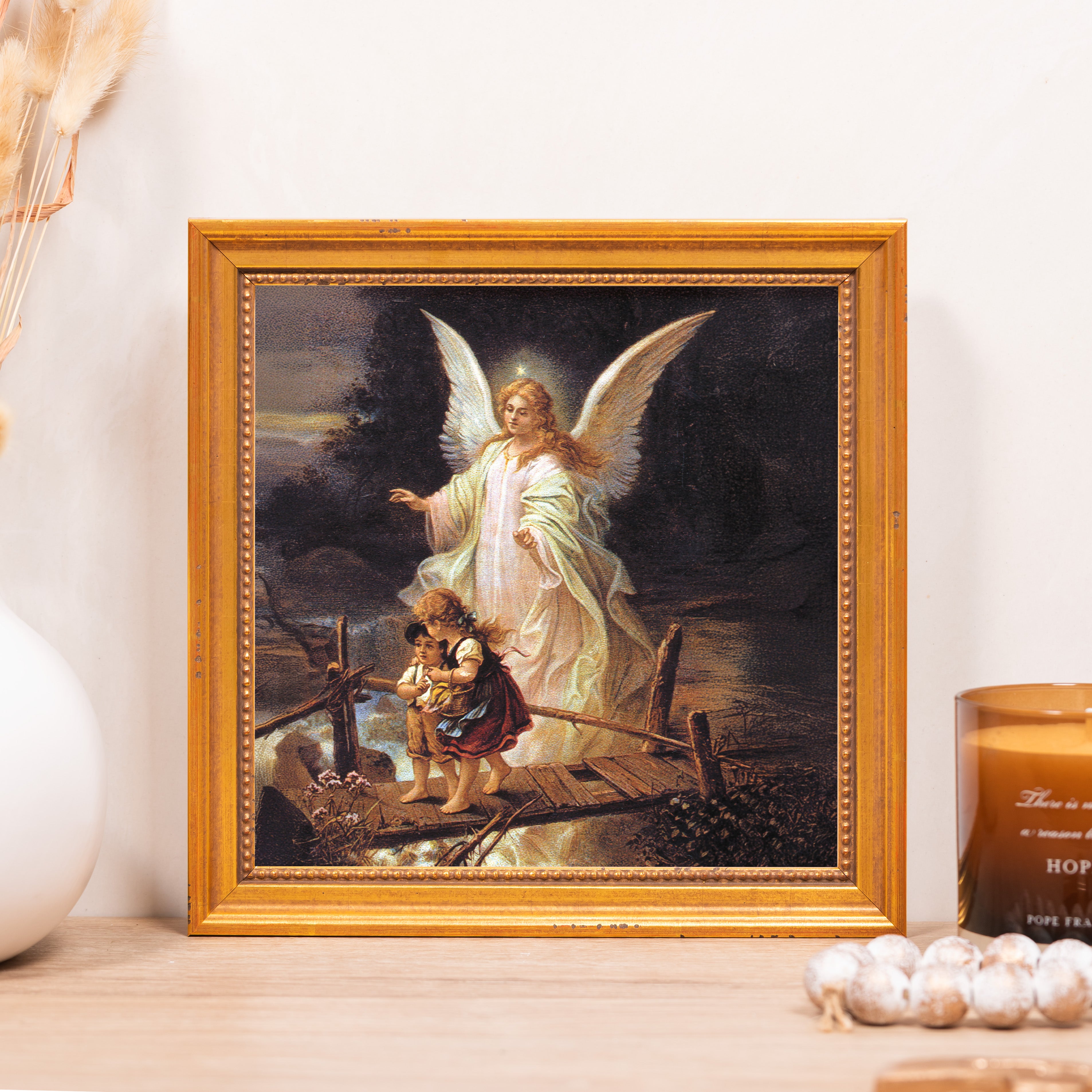 Framed print of an angel guiding two children on a bridge with a golden frame.