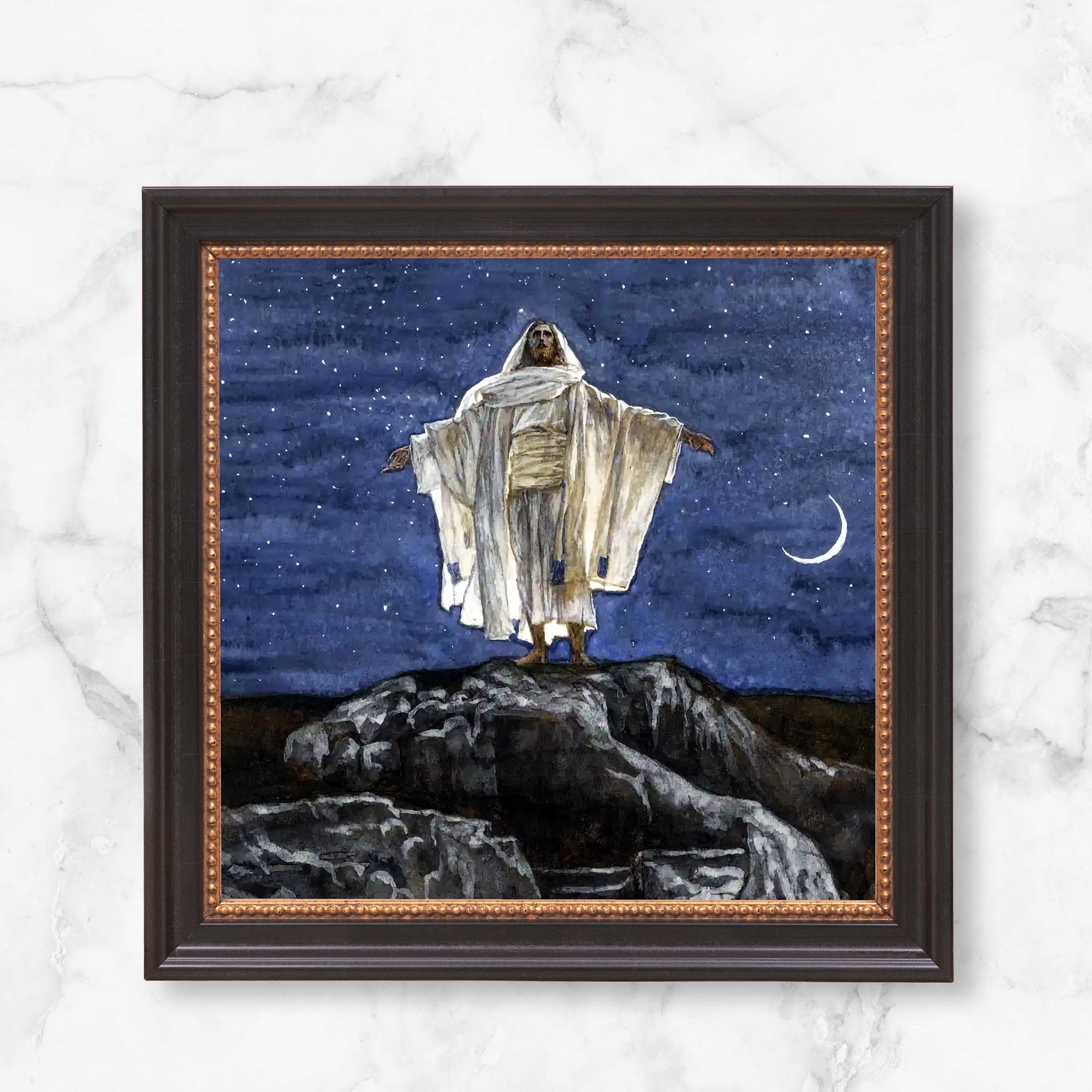 Framed watercolor painting of Jesus standing on a hill beneath a starry night sky and crescent moon.