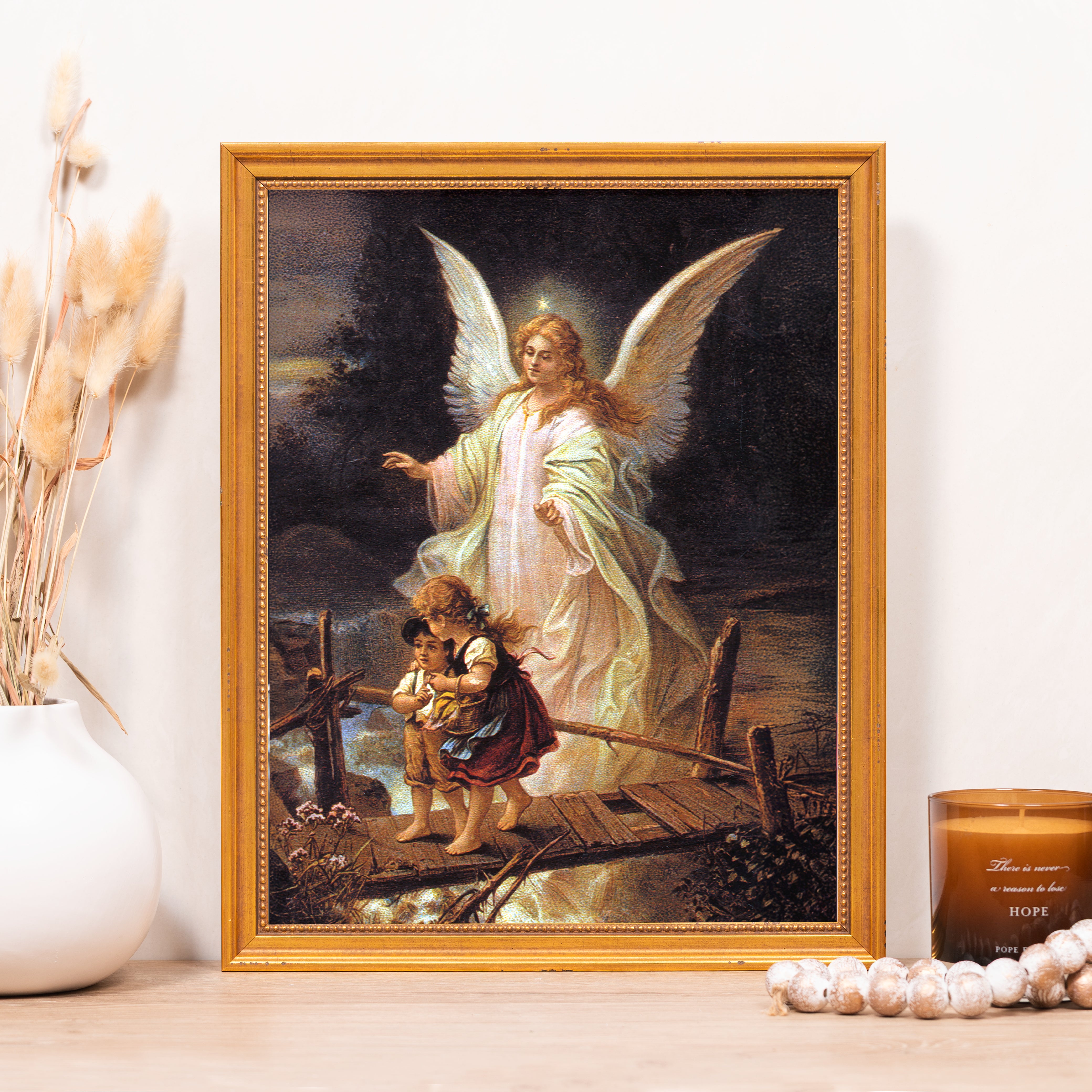 Framed art print of guardian angel guiding children, rendered in classic style with gold frame.