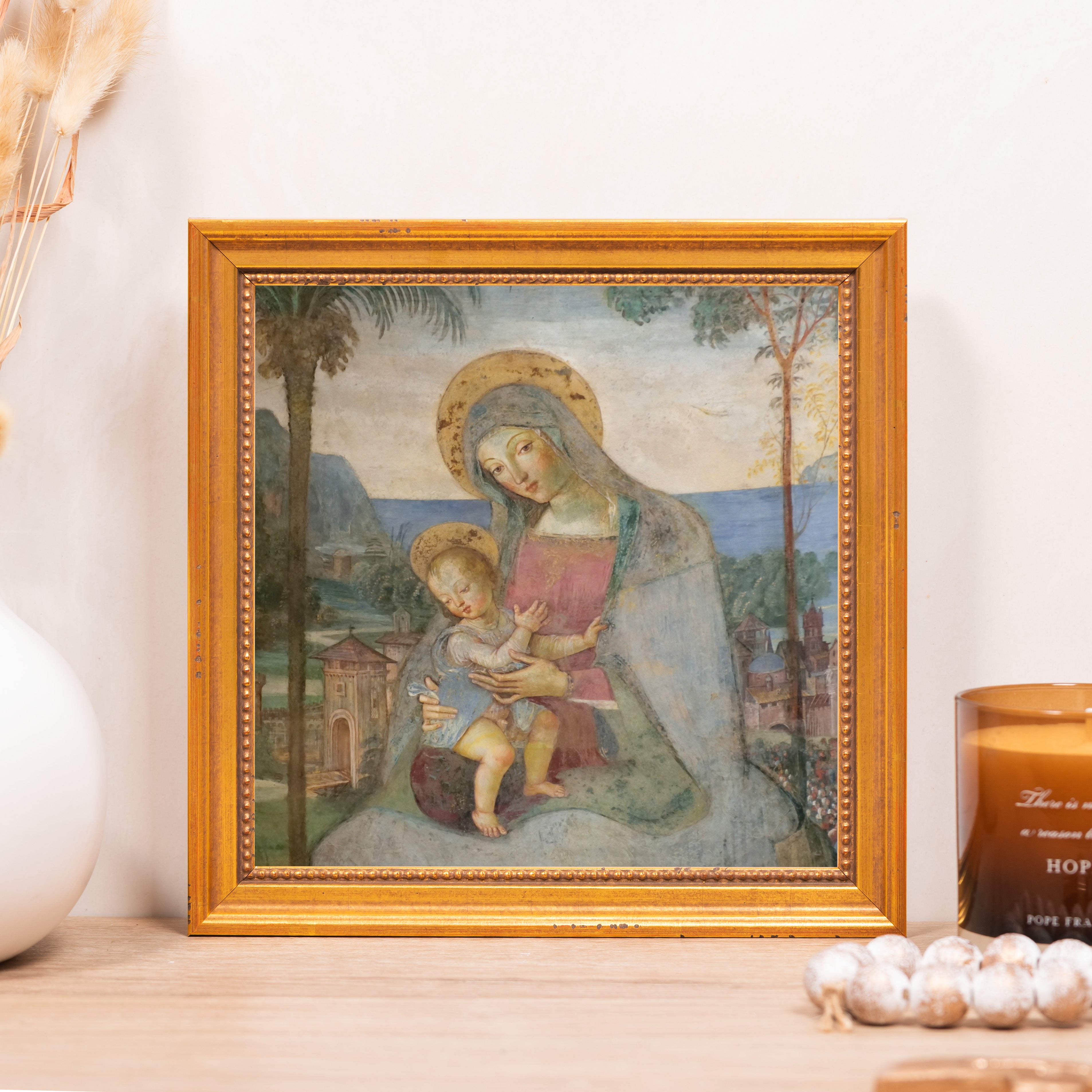Framed print of Madonna and child in classic style, gold frame.
