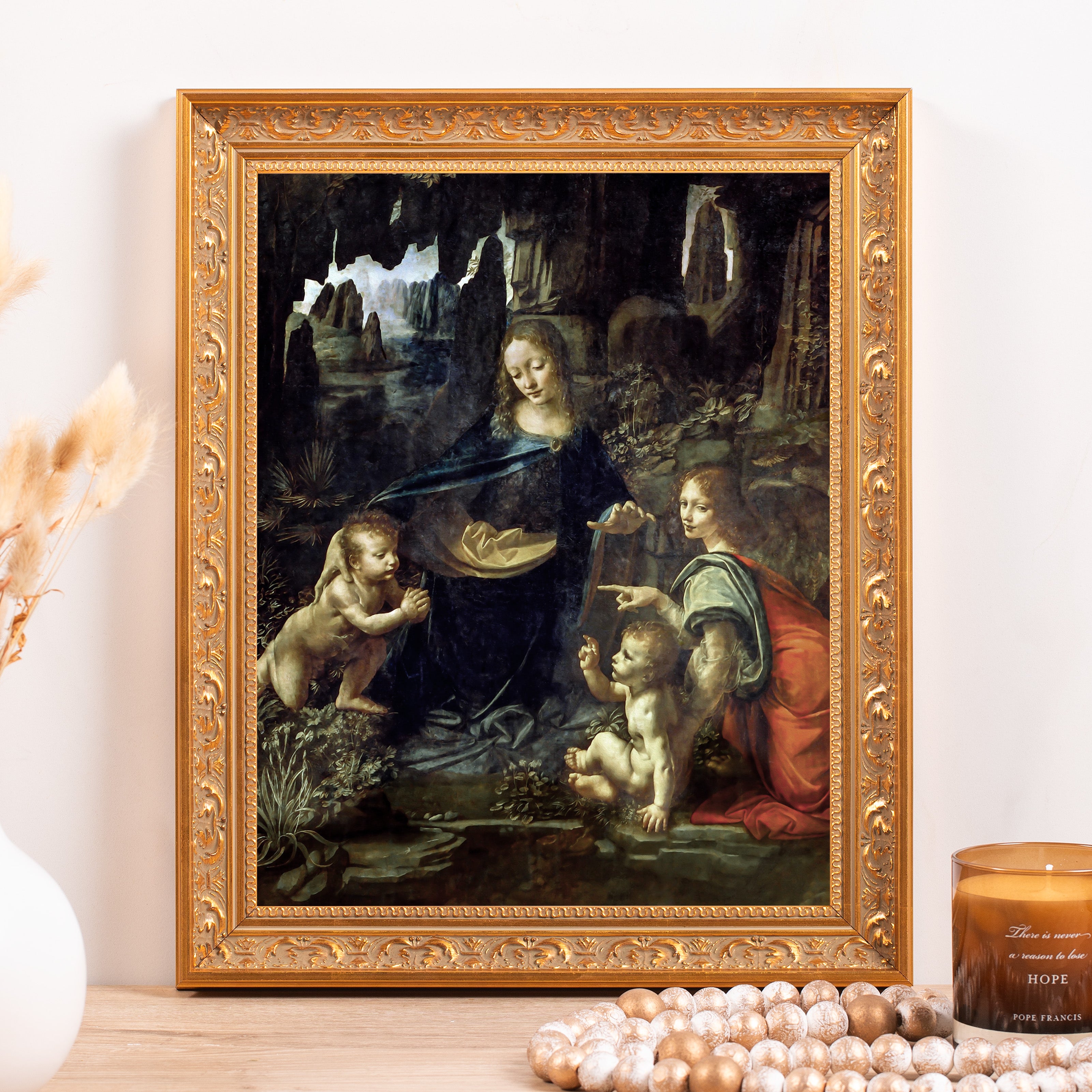 Framed print of Madonna of the Rocks in a gold, ornate frame for wall decor and art display.