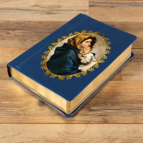 Closed Bible with blue leatherette cover and gold gilded pages, Virgin Mary with child illustration.
