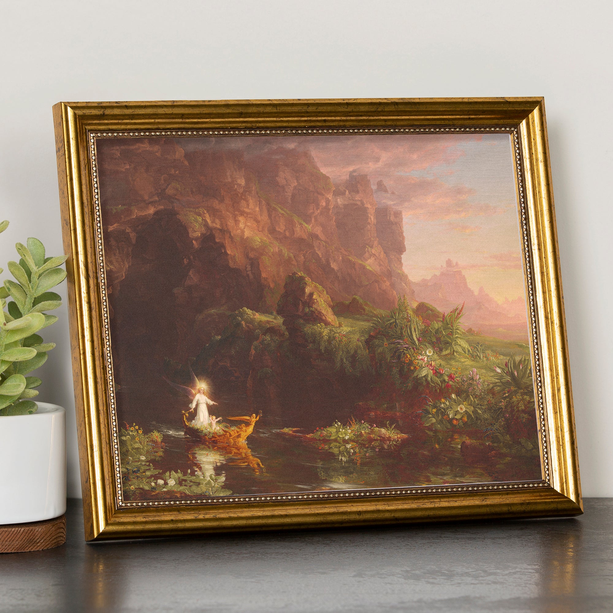 Framed print featuring angels in a landscape with an ornate gold frame.