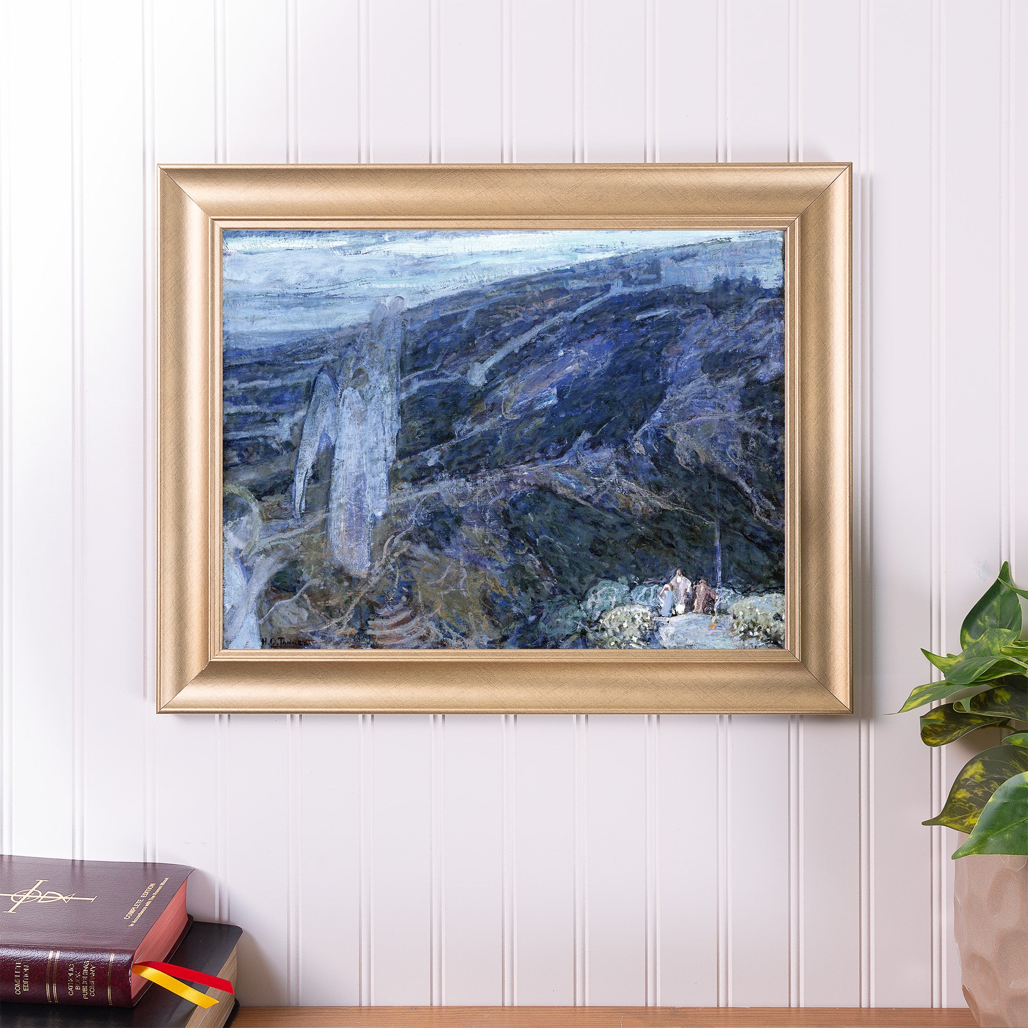 Framed painting on wall. Landscape art with figures in blues, gold frame.