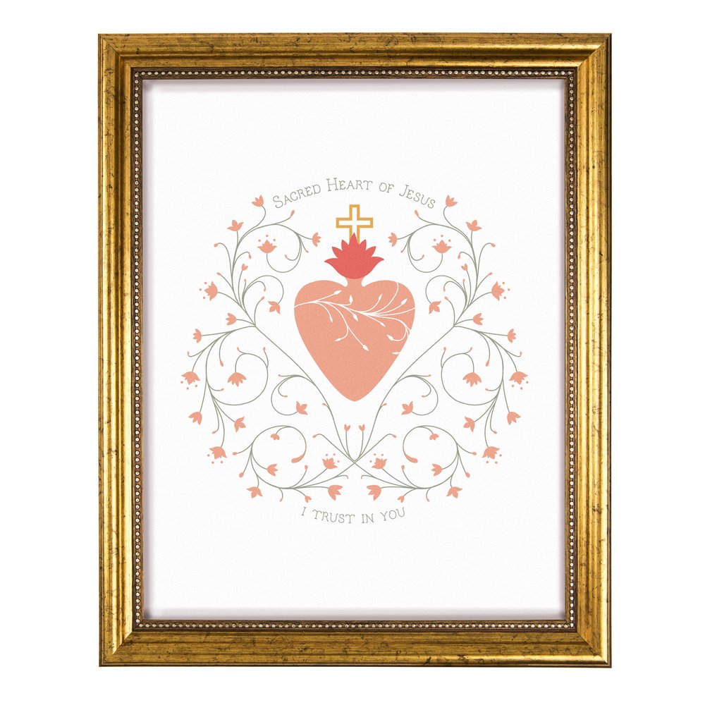 Framed print of Sacred Heart of Jesus with cross, floral details, and gold frame.