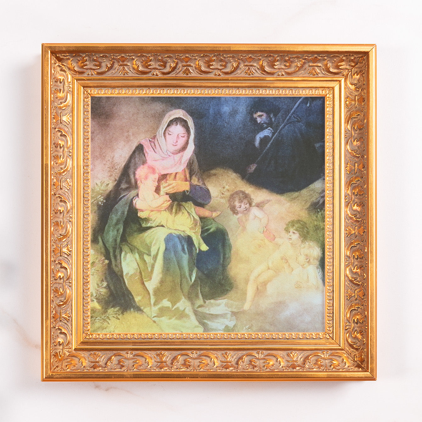 Framed art print of Mary, Joseph, and Jesus, with gold ornate frame.