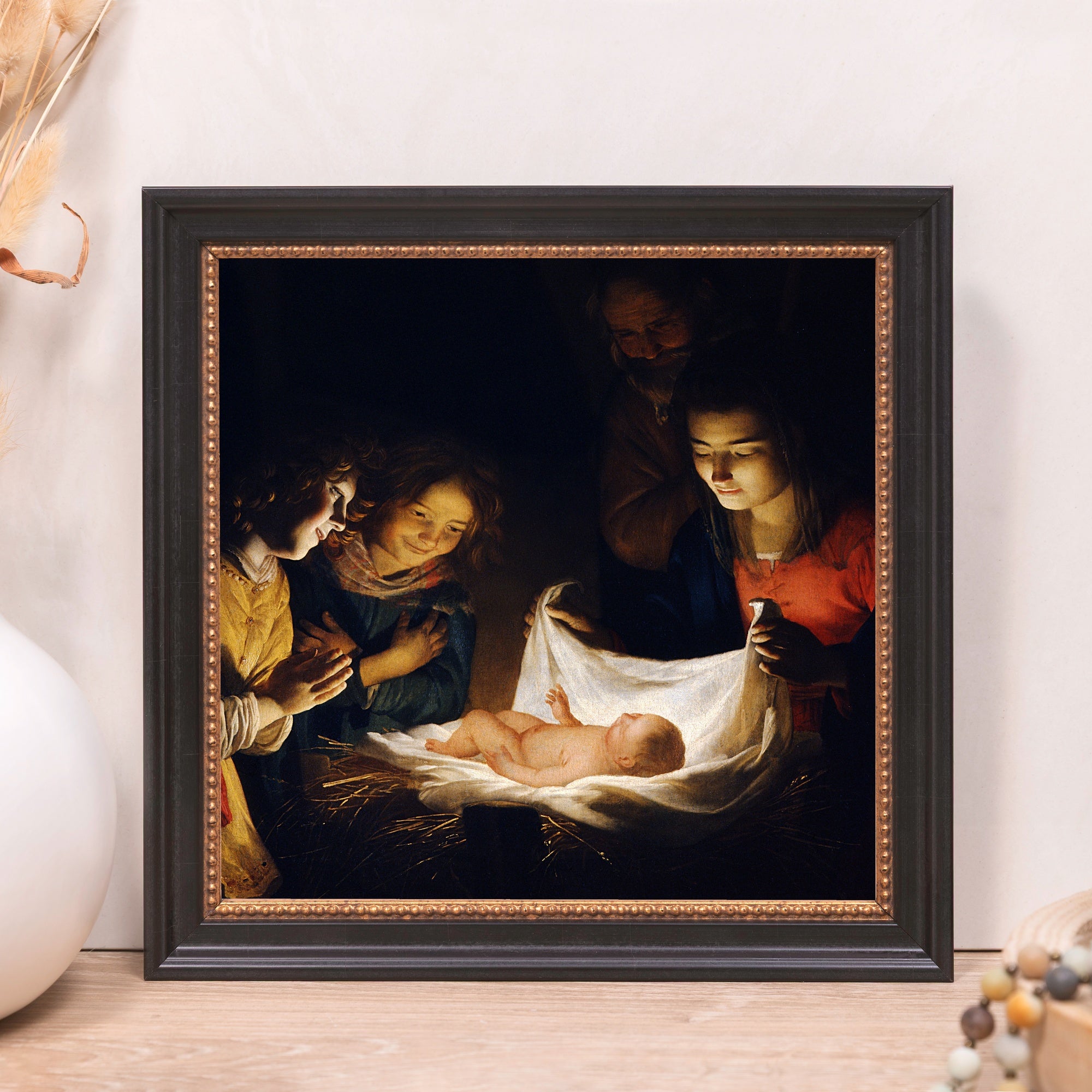 Framed painting of the Nativity scene with a dark brown, beaded frame.