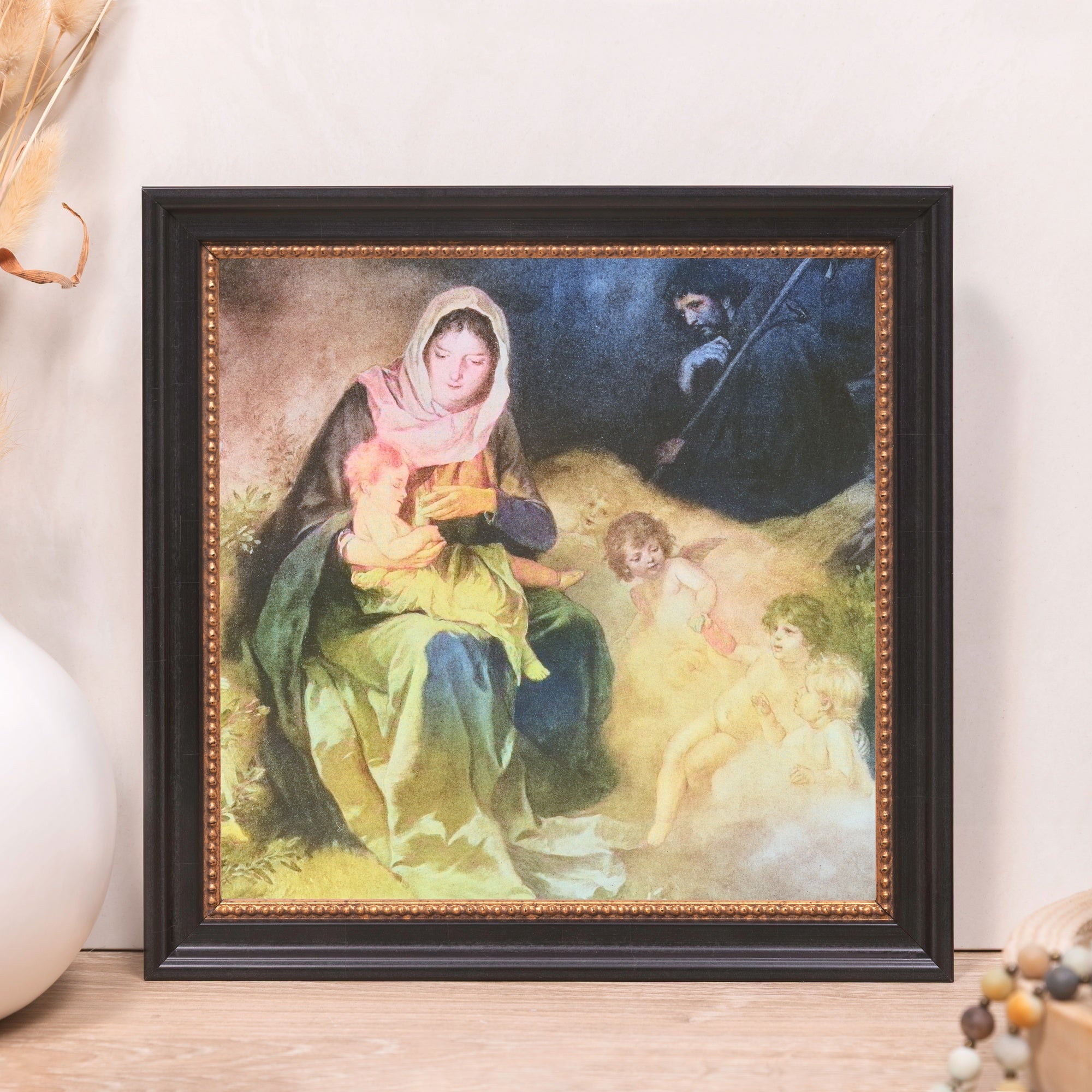 Framed Virgin Mary art print for Catholic faith featuring black wooden frame and golden accents.