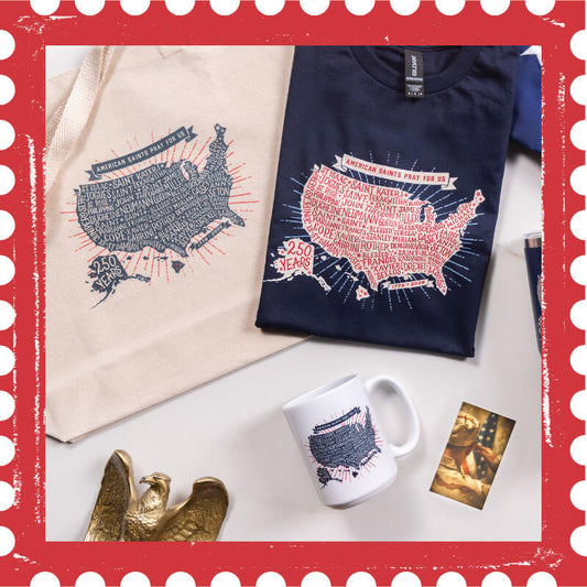 Navy sweatshirt with USA map design, white mug, beige tote bag, and decorative eagle on a white surface.