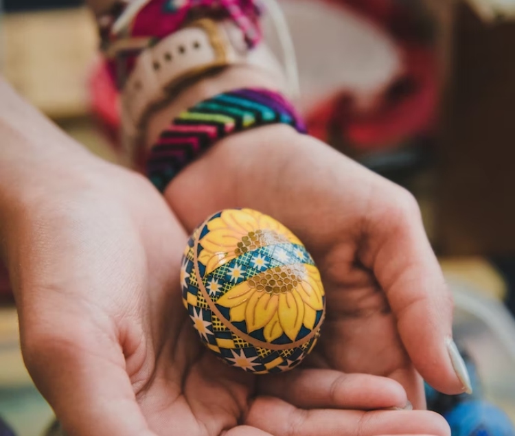 A pysanka is finished after the layers of design are written, waxed and dyed, then the wax is removed and the design revealed. Finally, a layer of varnish is applied for protection. 