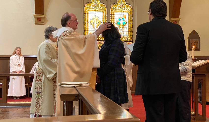Priest Lays Hands on the Elect - Photo Credit stjamessouthbend.org